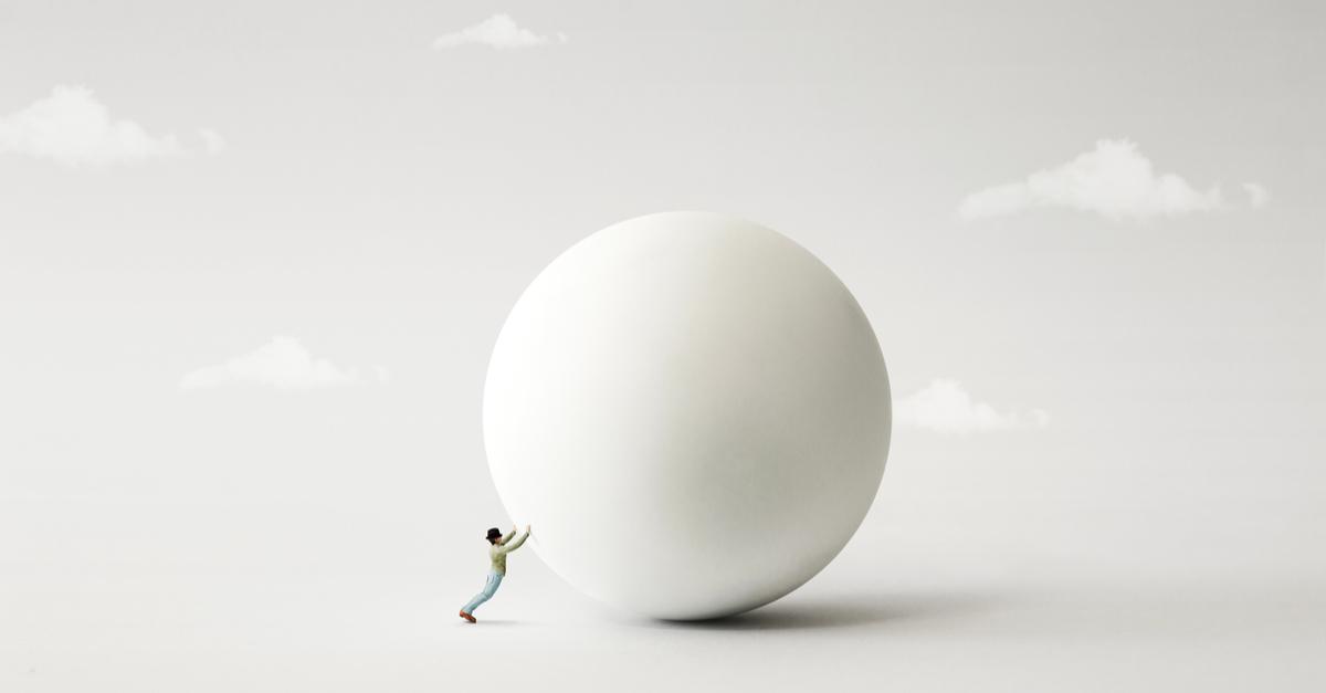Man pushing large ball, to signify how to implement a successful lead generation strategy